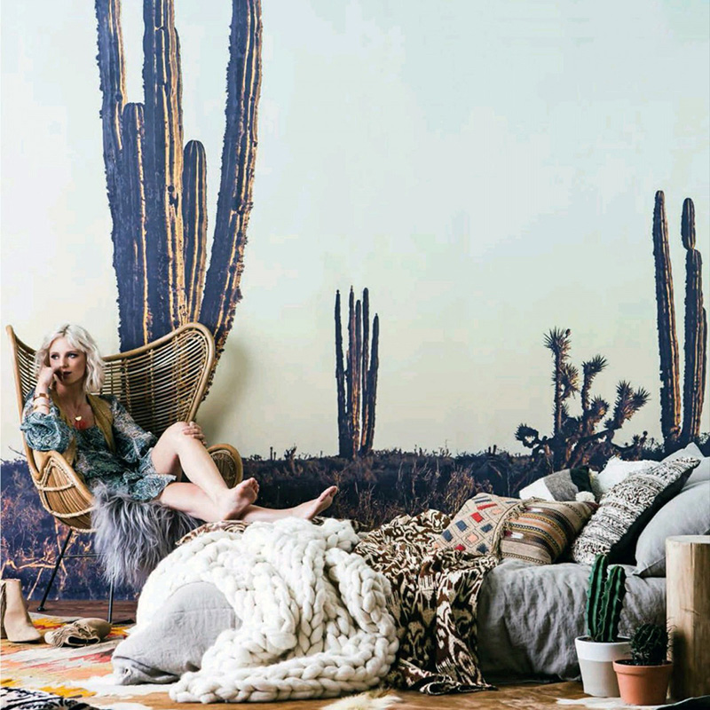 Cactus Mural on a wall with a relaxed woman sitting in front