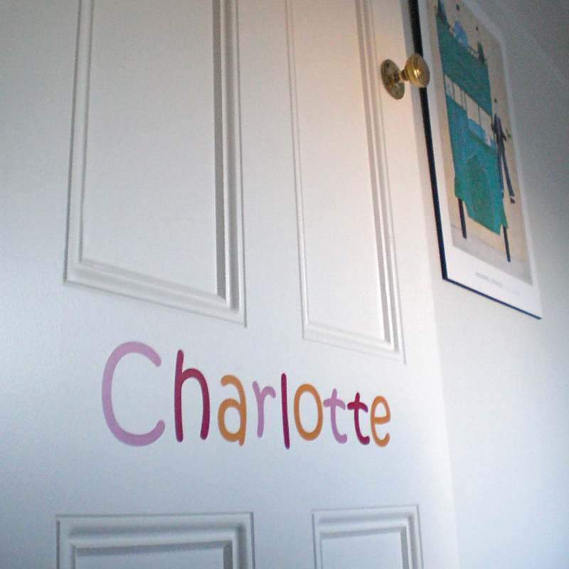 Cut out letters saying "Charlotte" on a bedroom door