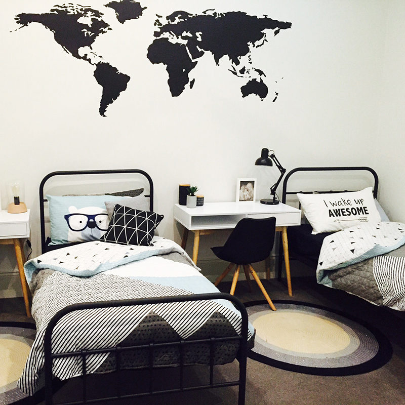 Shared child's bedroom with a black Silhouette World Map Wall Decal.