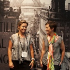 Two ladies standing in front of a black and white mural