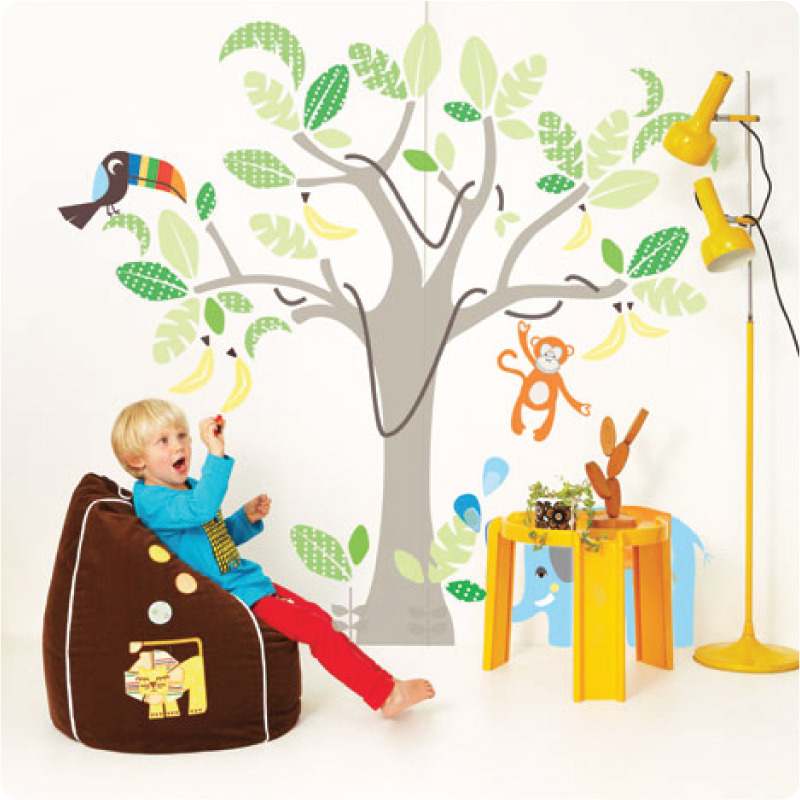 Jungle wall stickers with a boy in front sitting on a bag