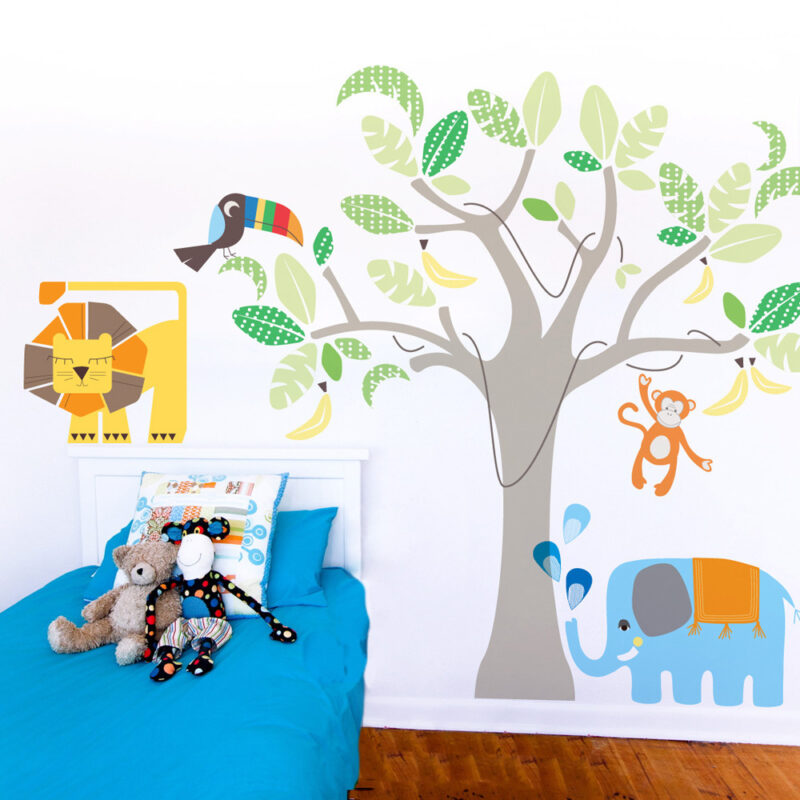 Jungle land removable wall stickers Cocoon Couture behind a blue child's bed