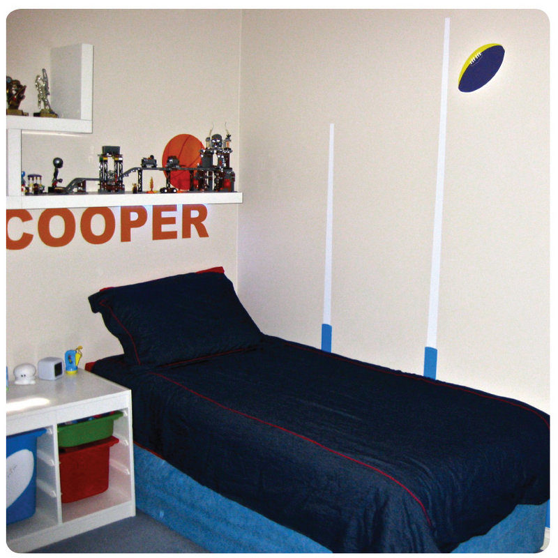 Footy removable wall stickers for boys room with child name Cooper behind the bed