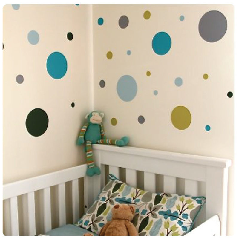 Polkadots removable wall stickers behind a white crib