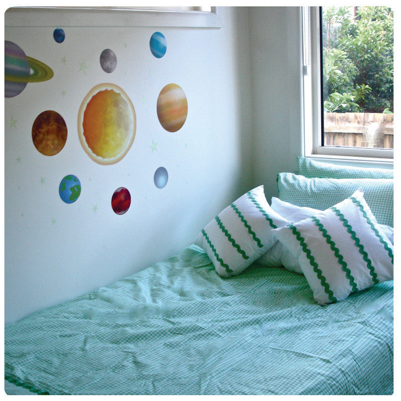 Space Removable Wall Stickers behind a green bed