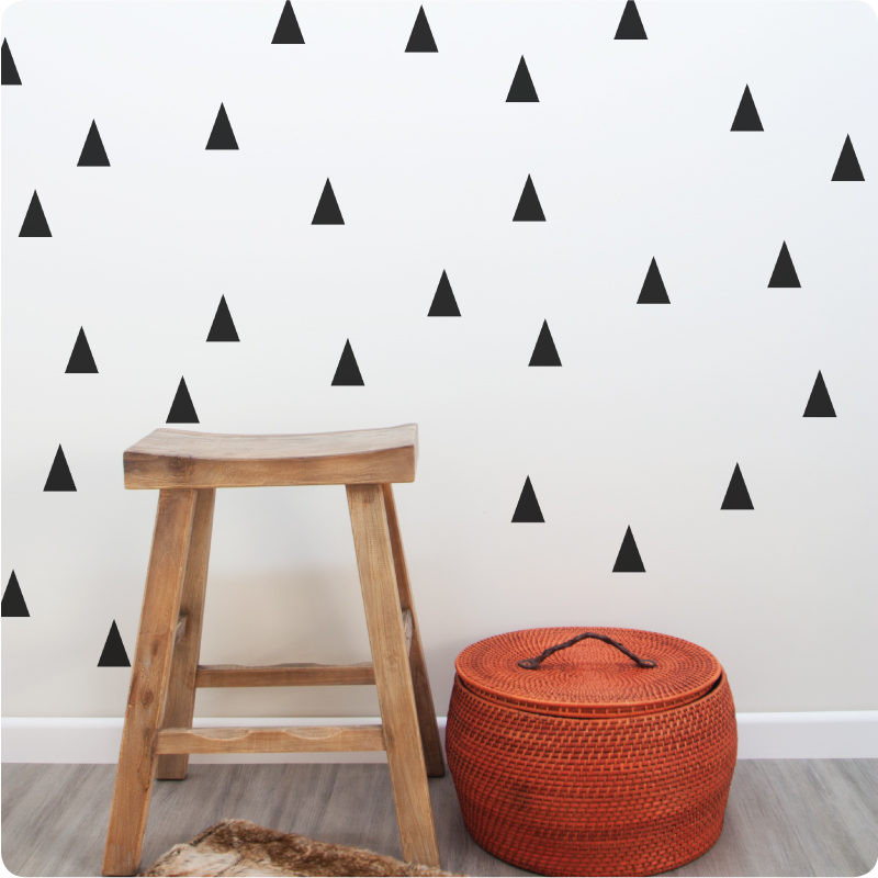 Triangle removable wall stickers decals behind a wooden chair and basket