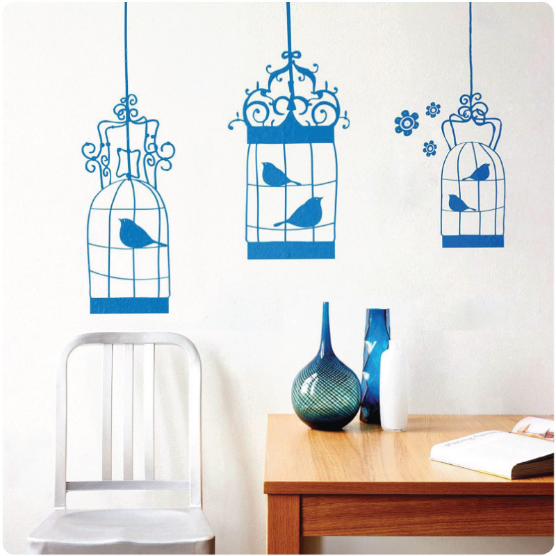 Birdcages removable wall stickers behind a chair and cabinet