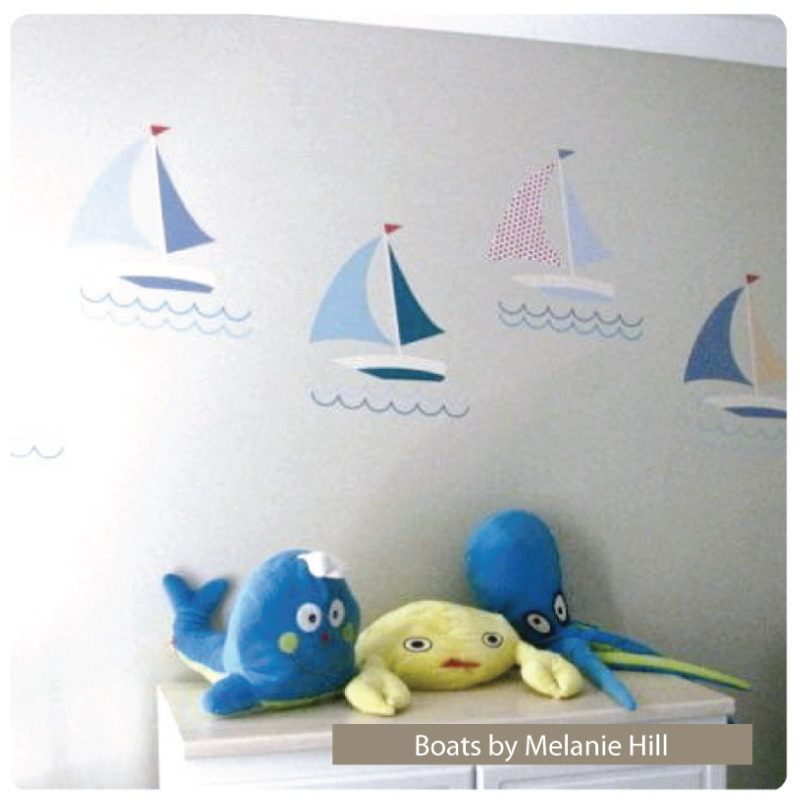 Boats removable wall stickers behind a cabinet with stuffed toys on top