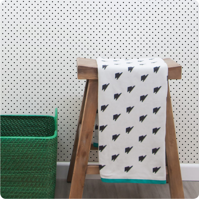 Dotty removable wallpaper Australia with wooden chair and basket in front