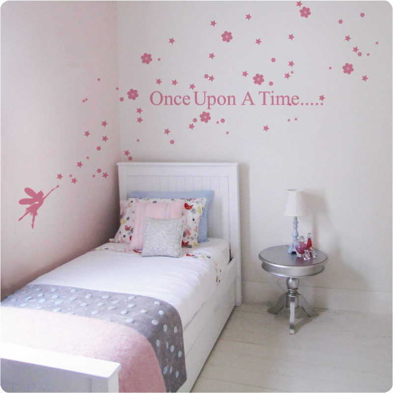 Fairy Story removable wall stickers behind a bed and round silver table