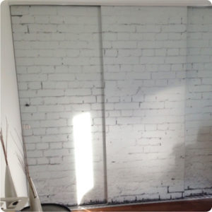 white brick wallpaper covering mirrored doors