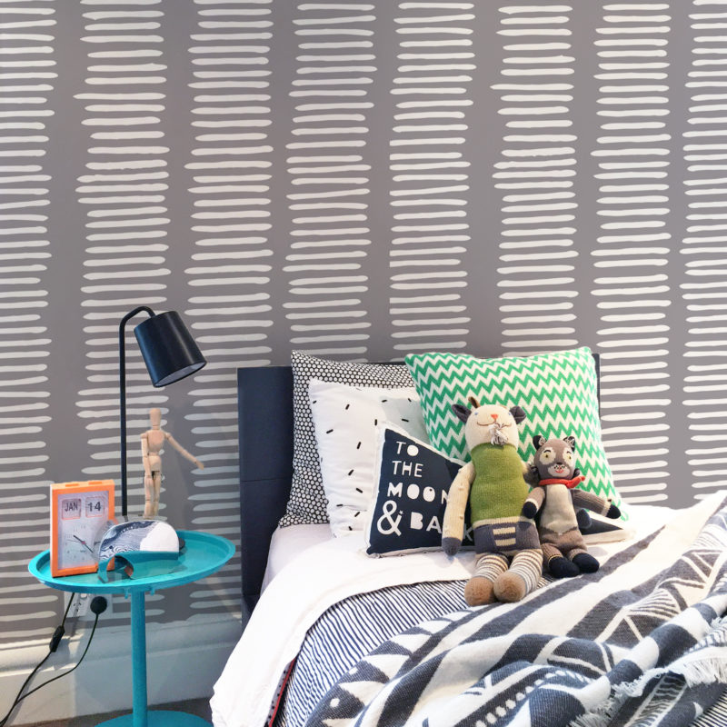 Stacks wallpaper in grey in a child's bedroom