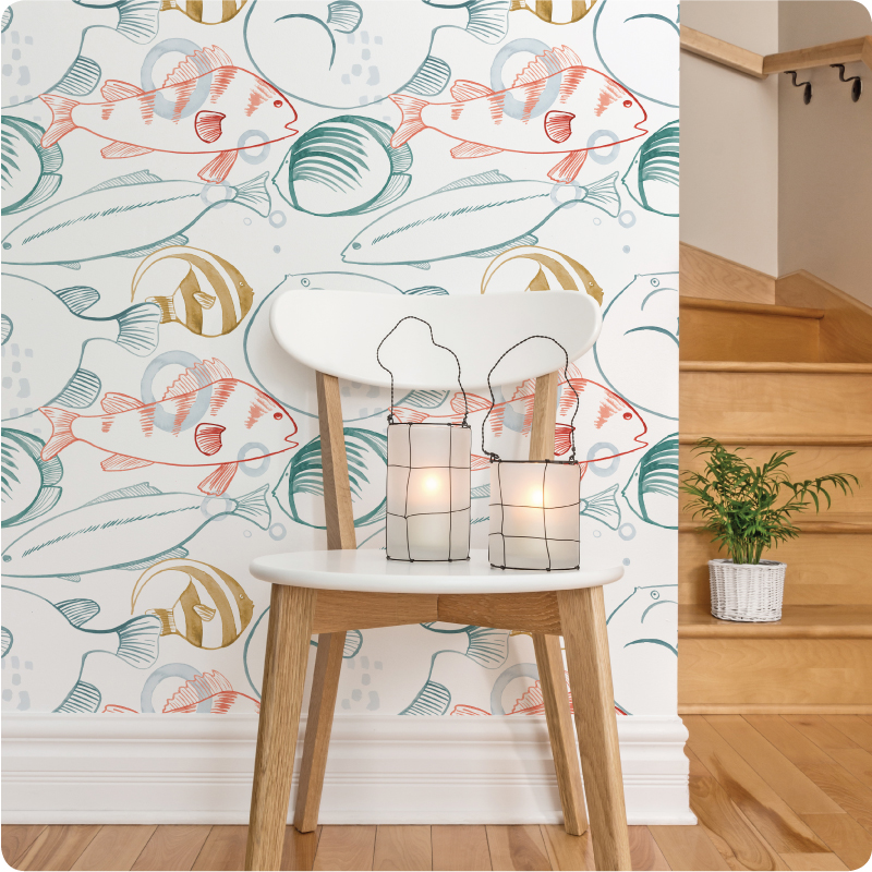 A 2 lamps sits on a chair in front of the Under the Sea wallpaper