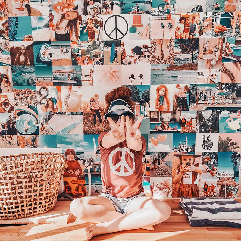 A small girl sitting in front of a photo collage
