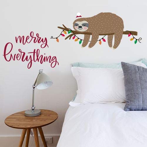 White bedroom with Christmas sloth wall sticker above bed