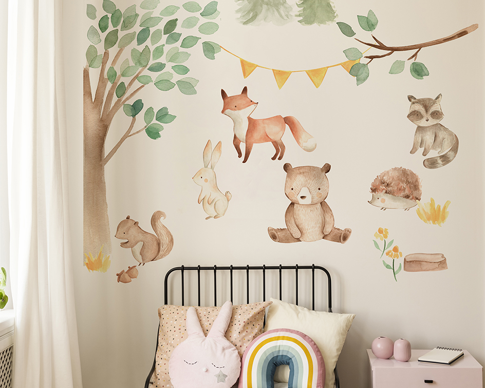 Watercoloured woodland animals wall stickers on a wall above a bed