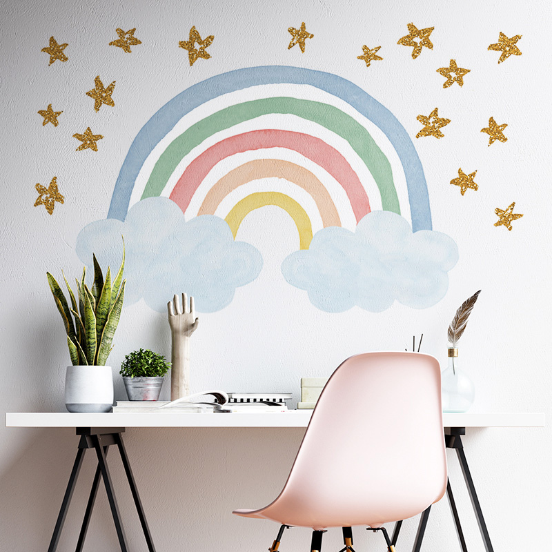 Water coloured rainbow wall decal on a wall behind a desk