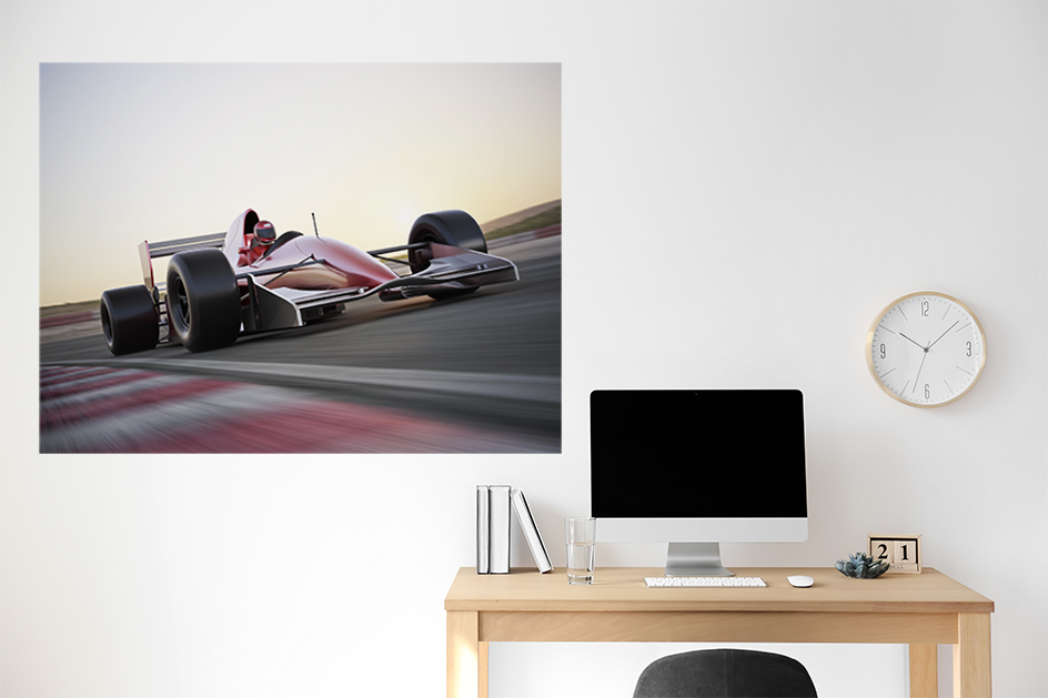 Formula 1 poster on a wall above a desk